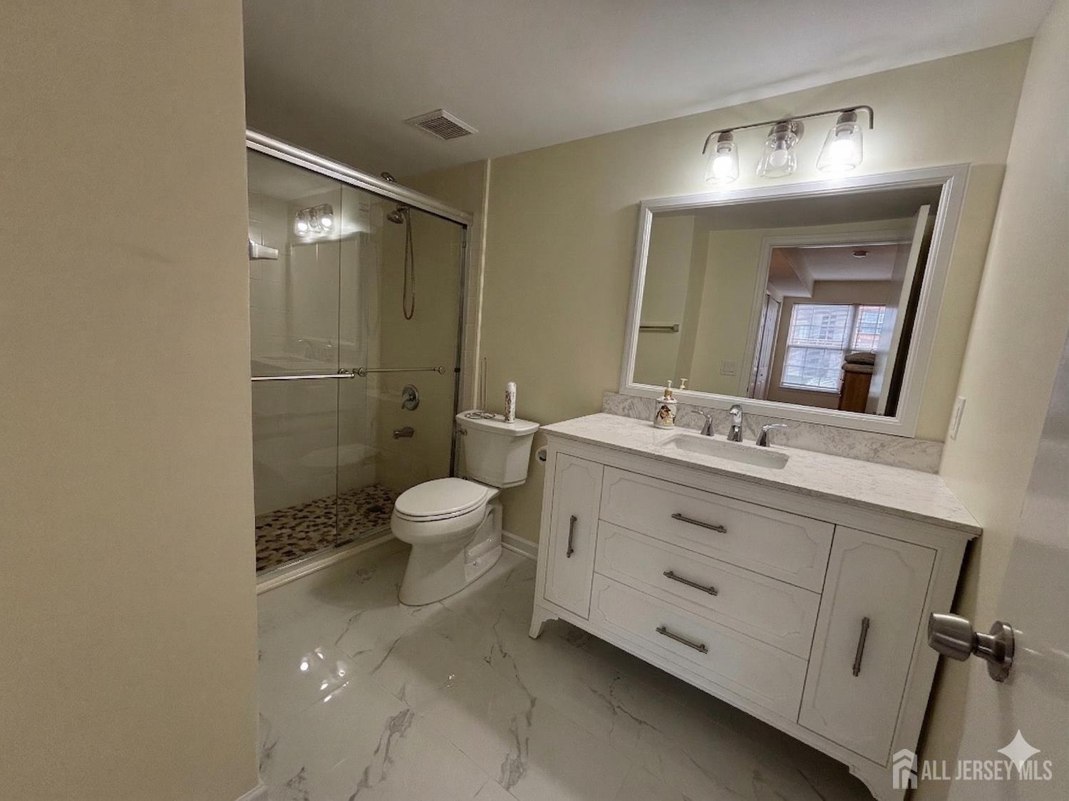 1301 Plymouth Road North Brunswick, NJ 08902 - Photo 12 of 21 a bathroom with a double vanity sink toilet mirror and shower