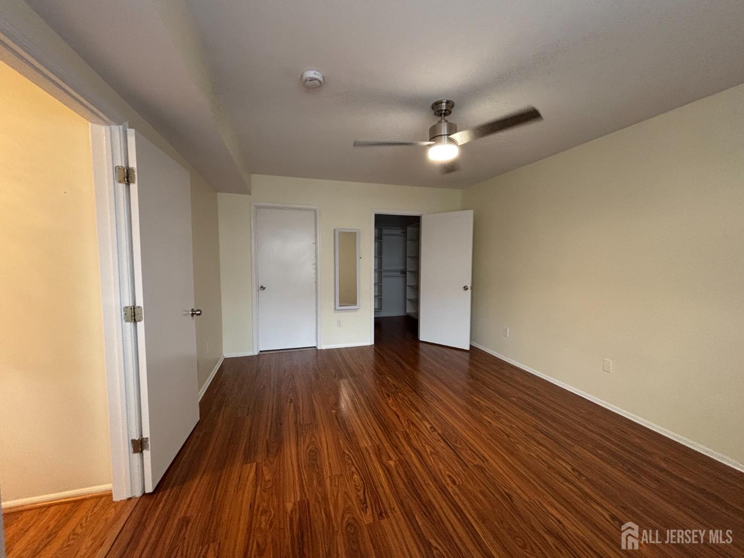 1301 Plymouth Road North Brunswick, NJ 08902 - Photo 15 of 21 a view of an empty room with wooden floor and a window