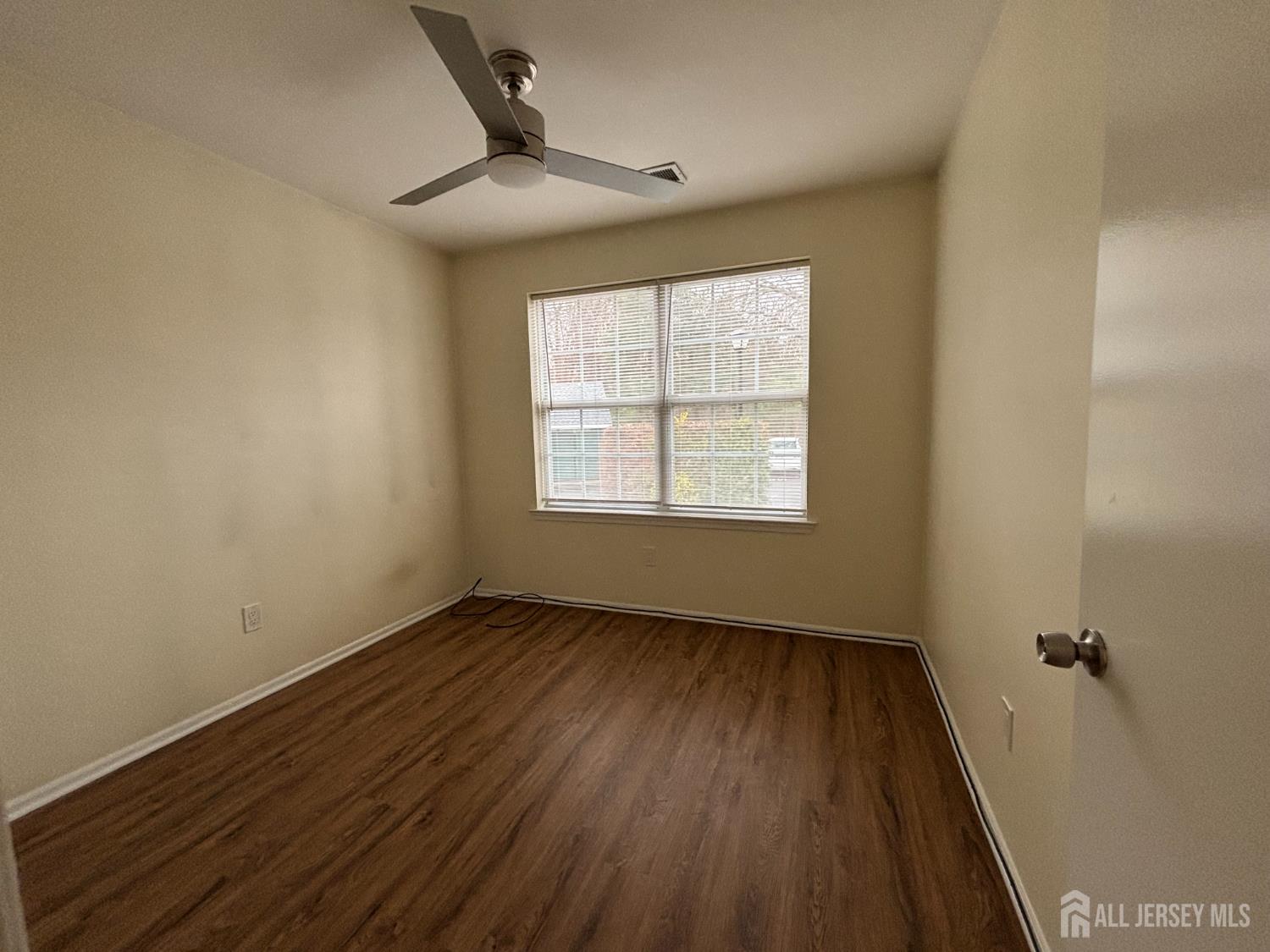 1301 Plymouth Road North Brunswick, NJ 08902 - Photo 16 of 21 a view of an empty room with wooden floor and a window