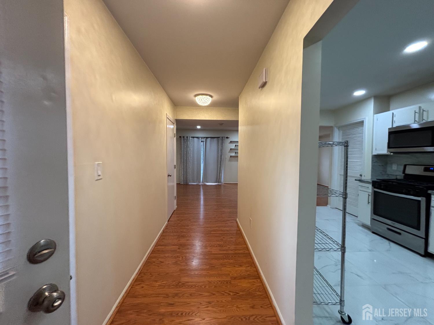 1301 Plymouth Road North Brunswick, NJ 08902 - Photo 18 of 21 a view of a hallway view with wooden floor and staircase