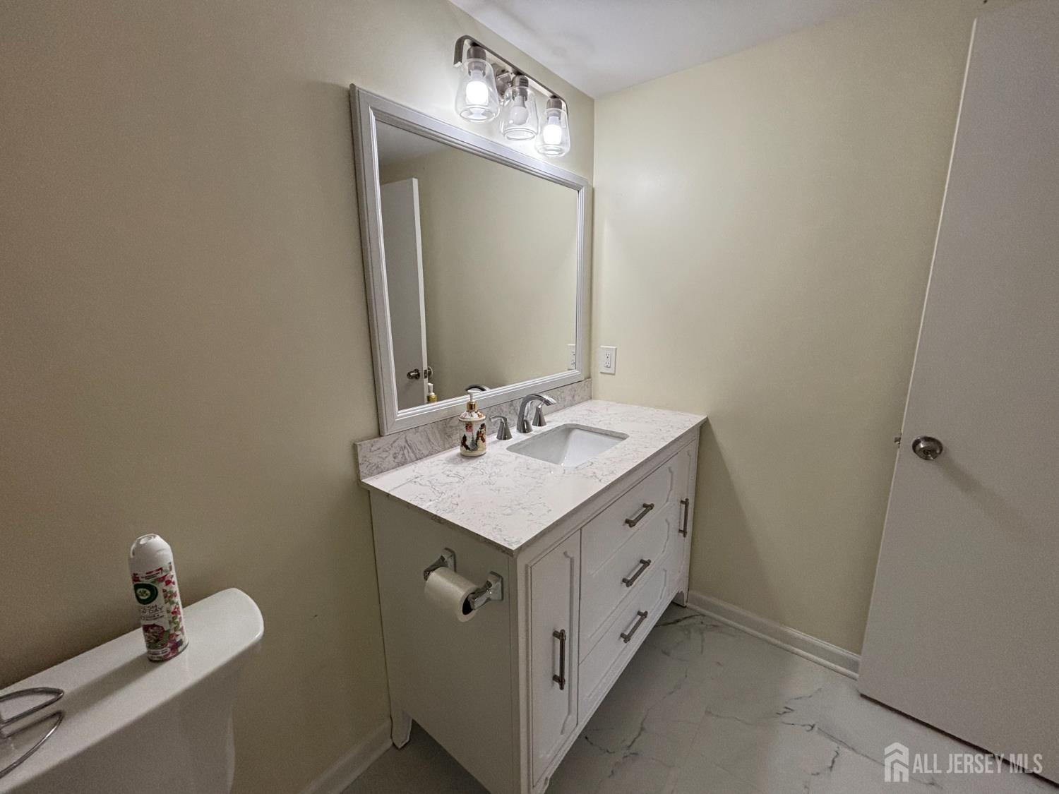 1301 Plymouth Road North Brunswick, NJ 08902 - Photo 19 of 21 a bathroom with a sink and a mirror