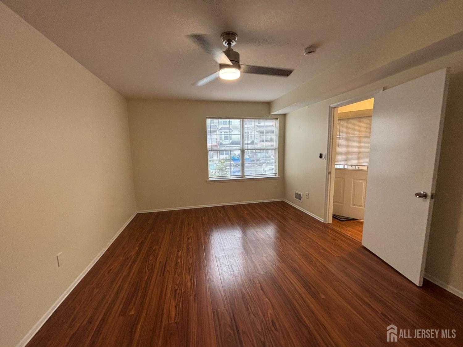 1301 Plymouth Road North Brunswick, NJ 08902 - Photo 10 of 21 an empty room with wooden floor and windows