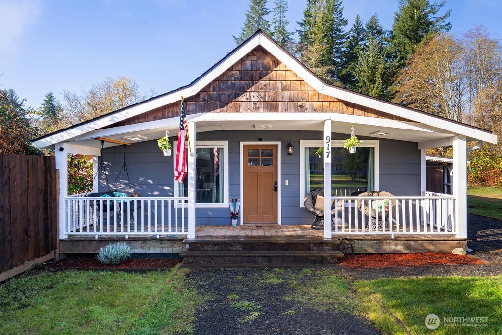 a view of a house with a yard and deck