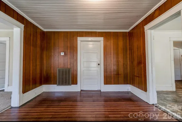 a view of door with wooden floor
