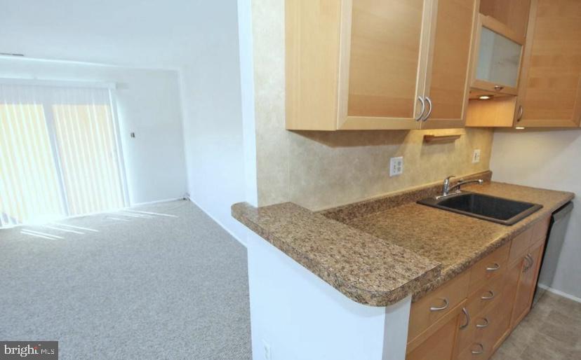 1003 Britton Place Voorhees, NJ 08043 - Photo 7 of 16 a kitchen with a sink a cabinets and window