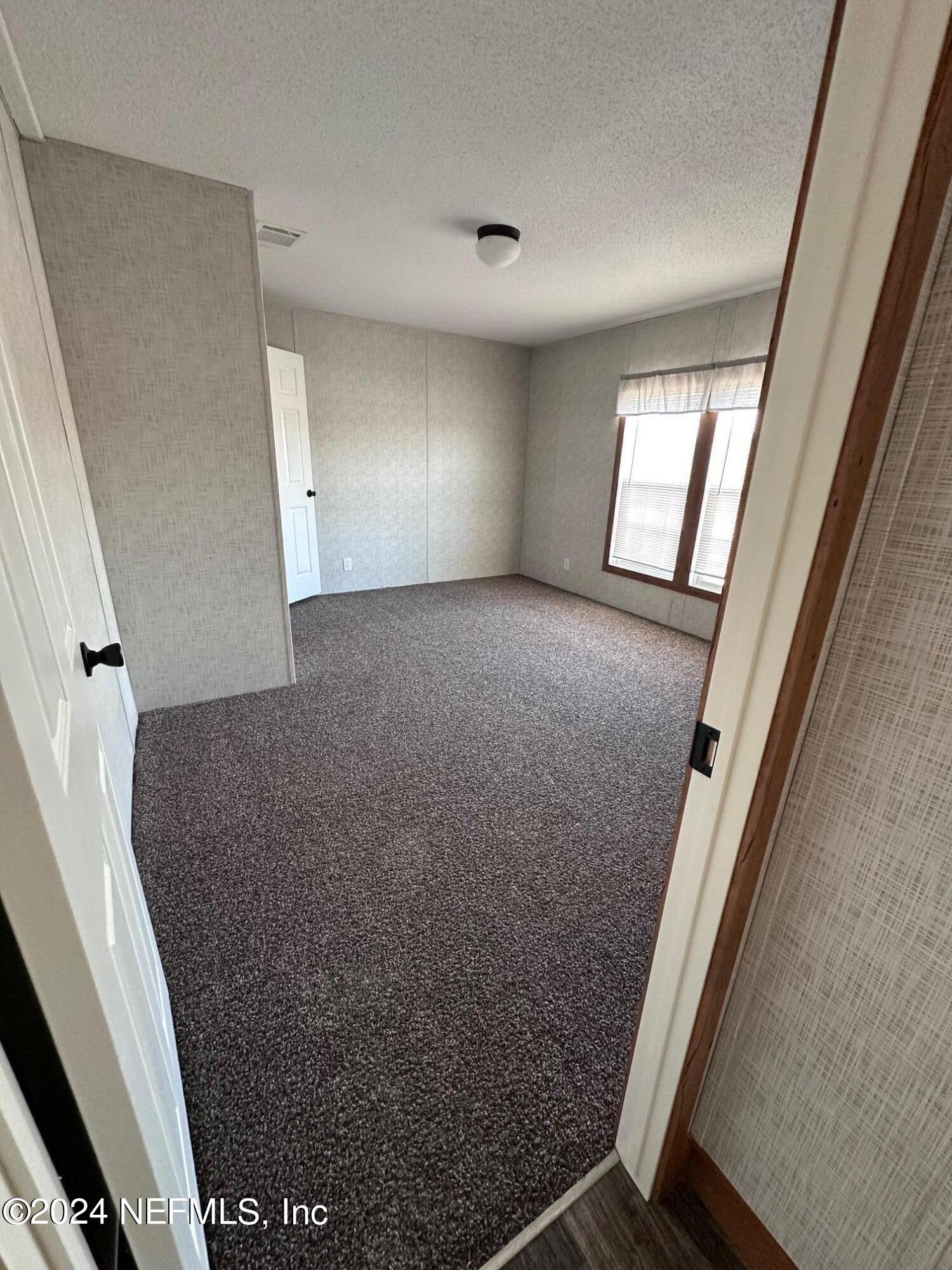 8682 Noah Davis Road Glen St. Mary, FL 32040 - Photo 11 of 19 an empty room with windows