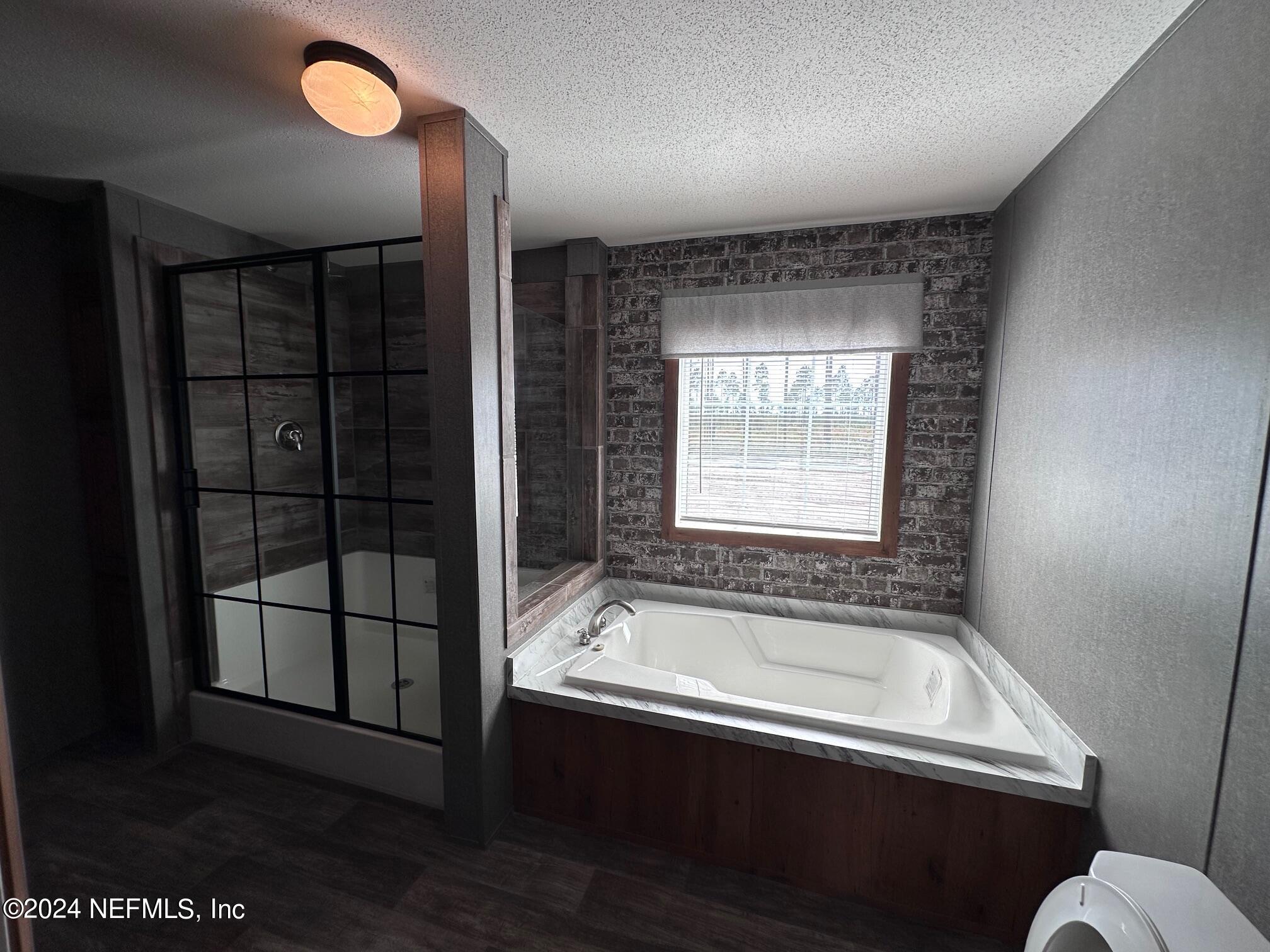 8682 Noah Davis Road Glen St. Mary, FL 32040 - Photo 13 of 19 a bathroom with a bathtub and a sink