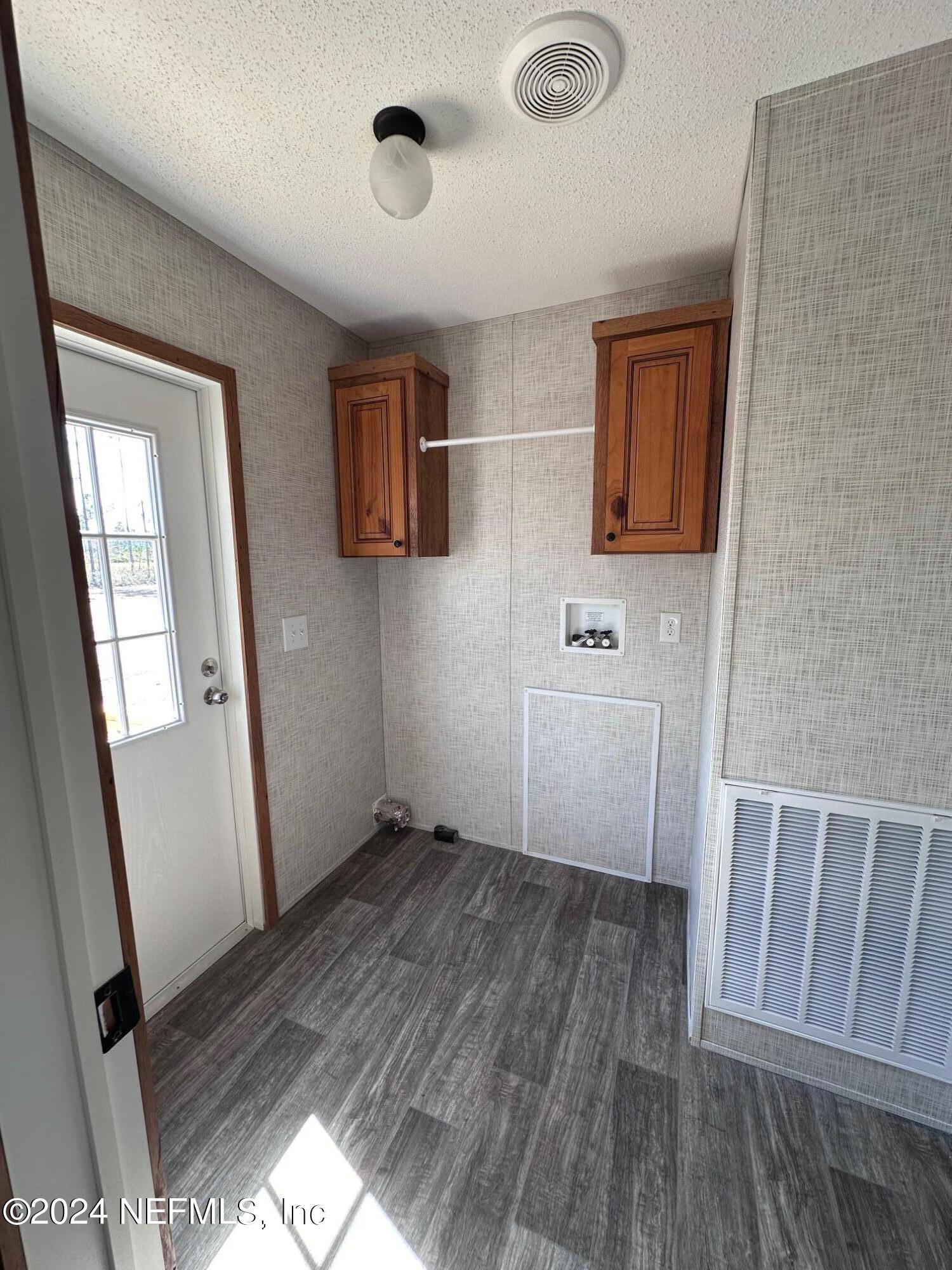 8682 Noah Davis Road Glen St. Mary, FL 32040 - Photo 16 of 19 a view of a hallway with wooden floor and a bathroom
