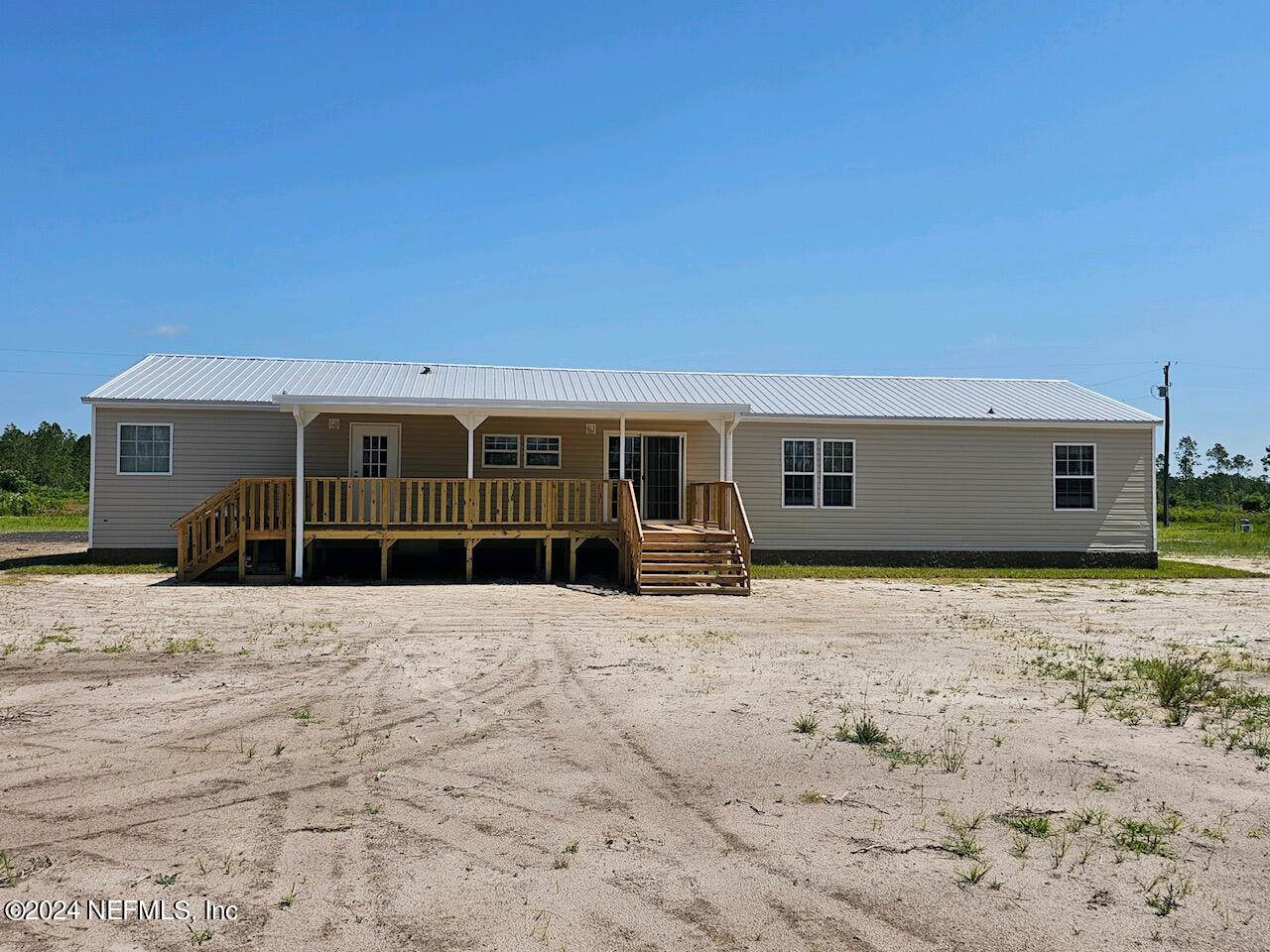 8682 Noah Davis Road Glen St. Mary, FL 32040 - Photo 18 of 19 a house with trees in the background