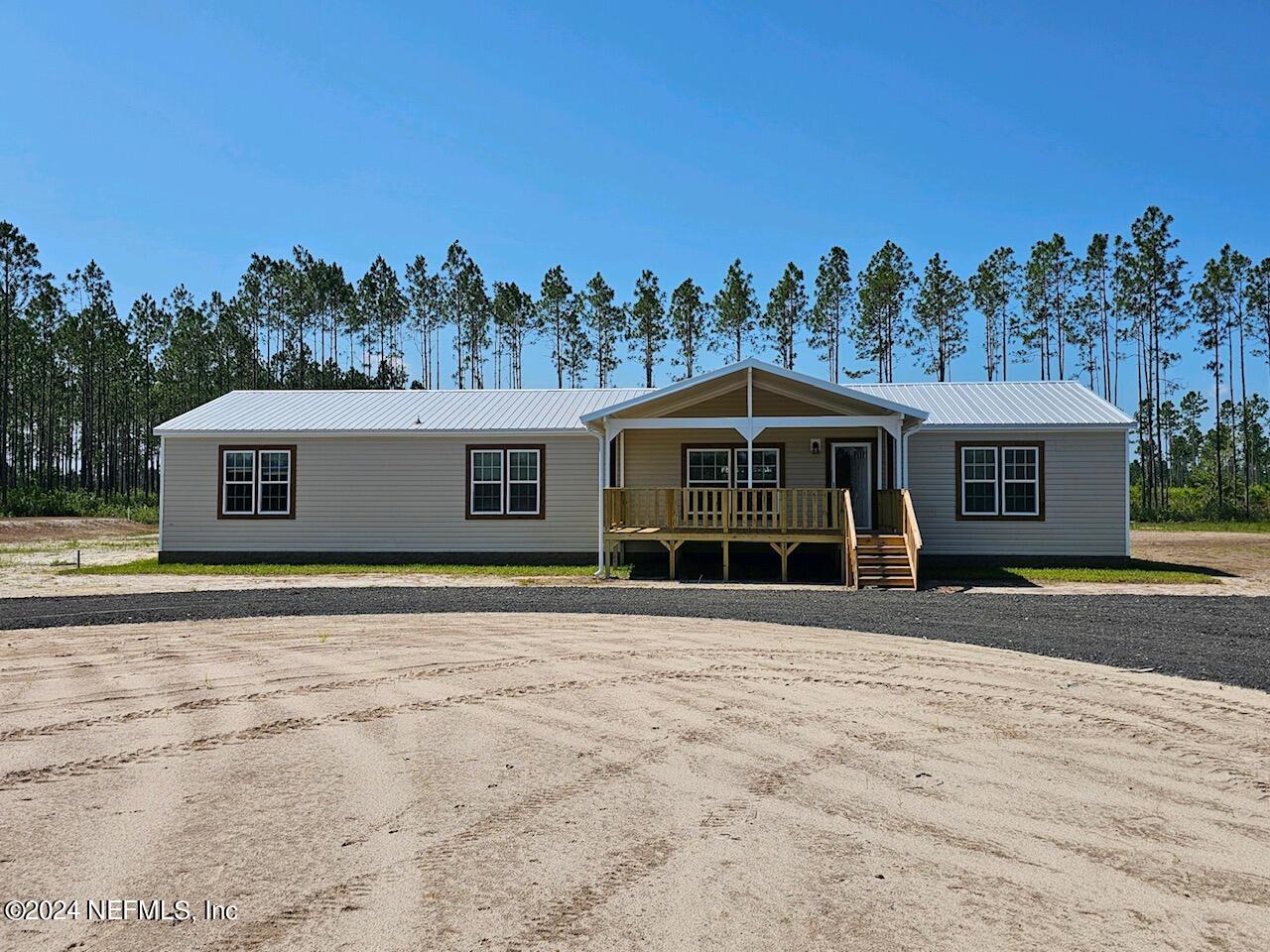 8682 Noah Davis Road Glen St. Mary, FL 32040 - Photo 2 of 19 a front view of a house with a yard
