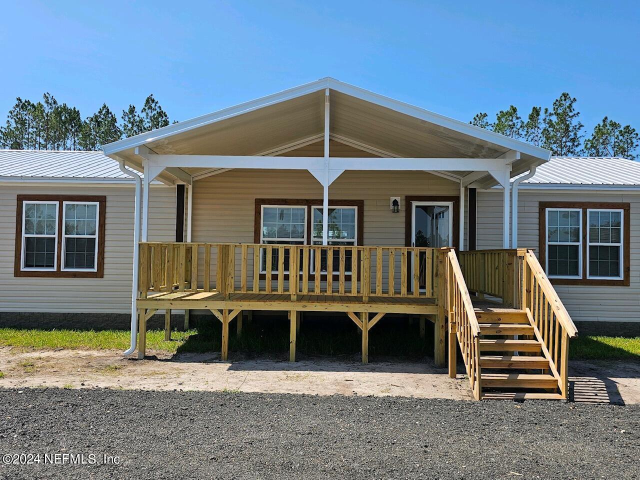 8682 Noah Davis Road Glen St. Mary, FL 32040 - Photo 3 of 19 a front view of a house with a porch