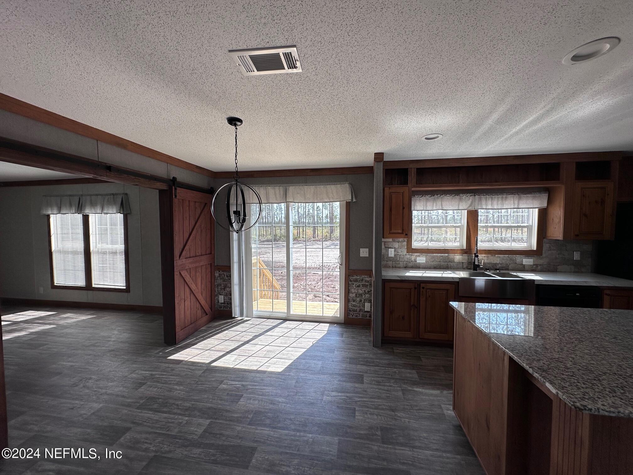 8682 Noah Davis Road Glen St. Mary, FL 32040 - Photo 8 of 19 a large hall with wooden floor and windows