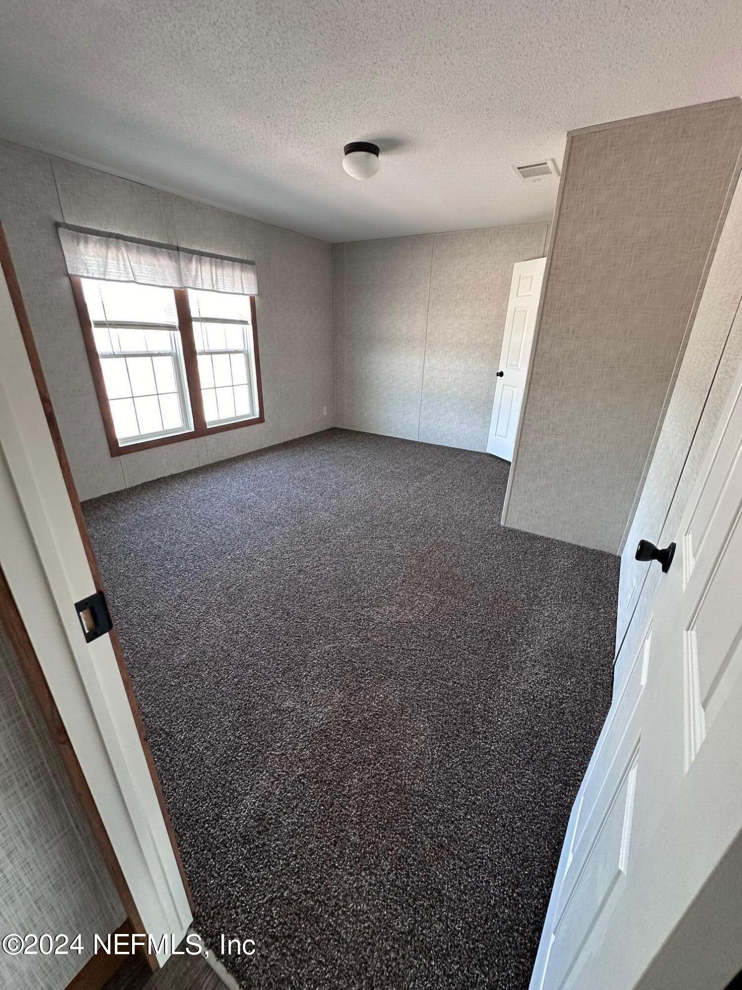 8682 Noah Davis Road Glen St. Mary, FL 32040 - Photo 10 of 19 a view of an empty room with a window