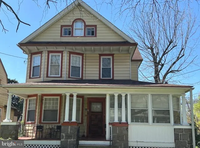 a view of a white house with large windows