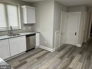 a view of a kitchen with sink and dishwasher