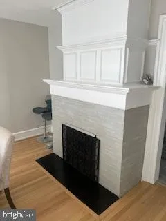 a living room with a fireplace and a rug