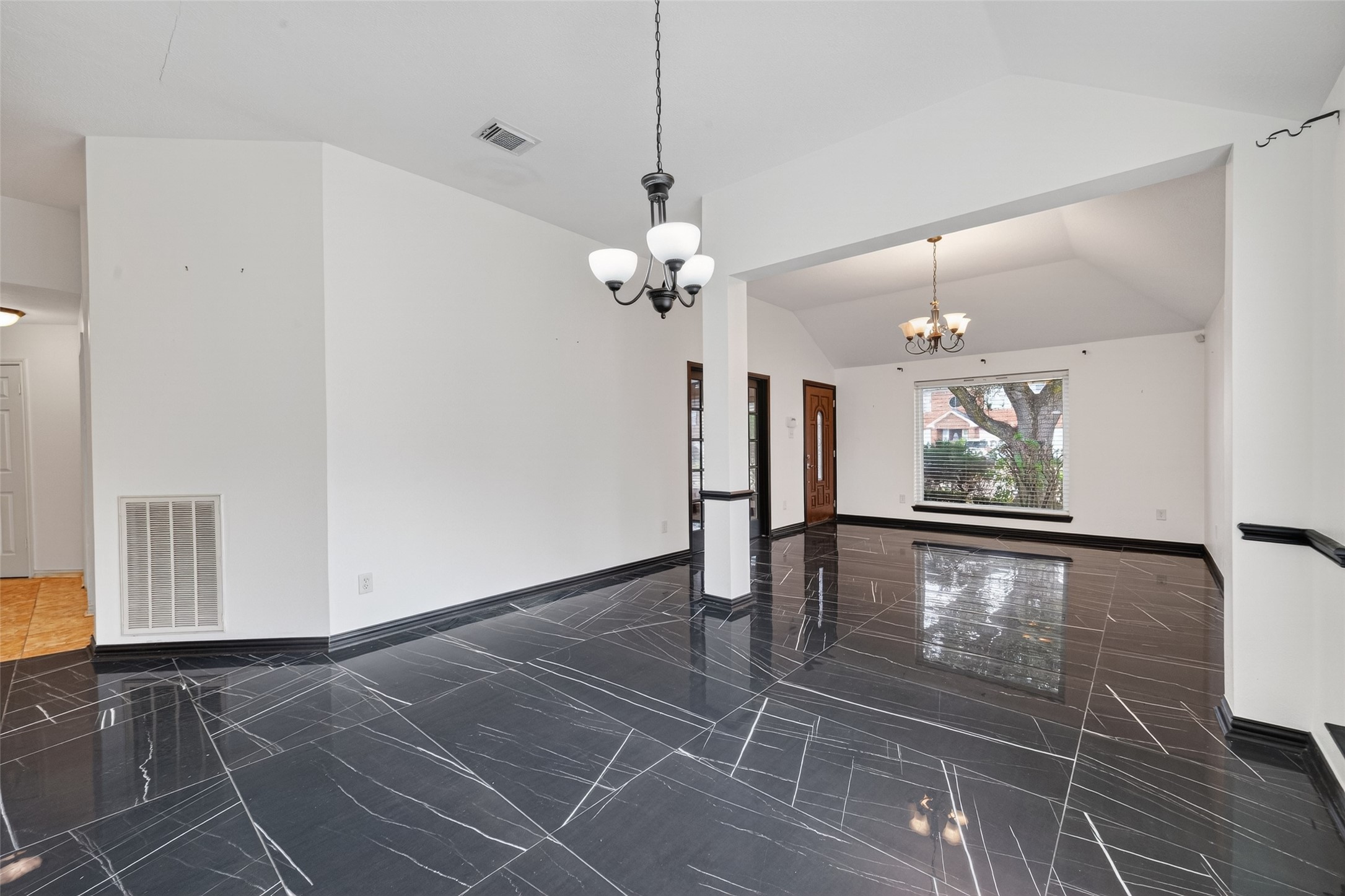 2214 Ruffian Lane Stafford, TX 77477 - Photo 11 of 31 a view of a room with wooden floor a chandelier and window