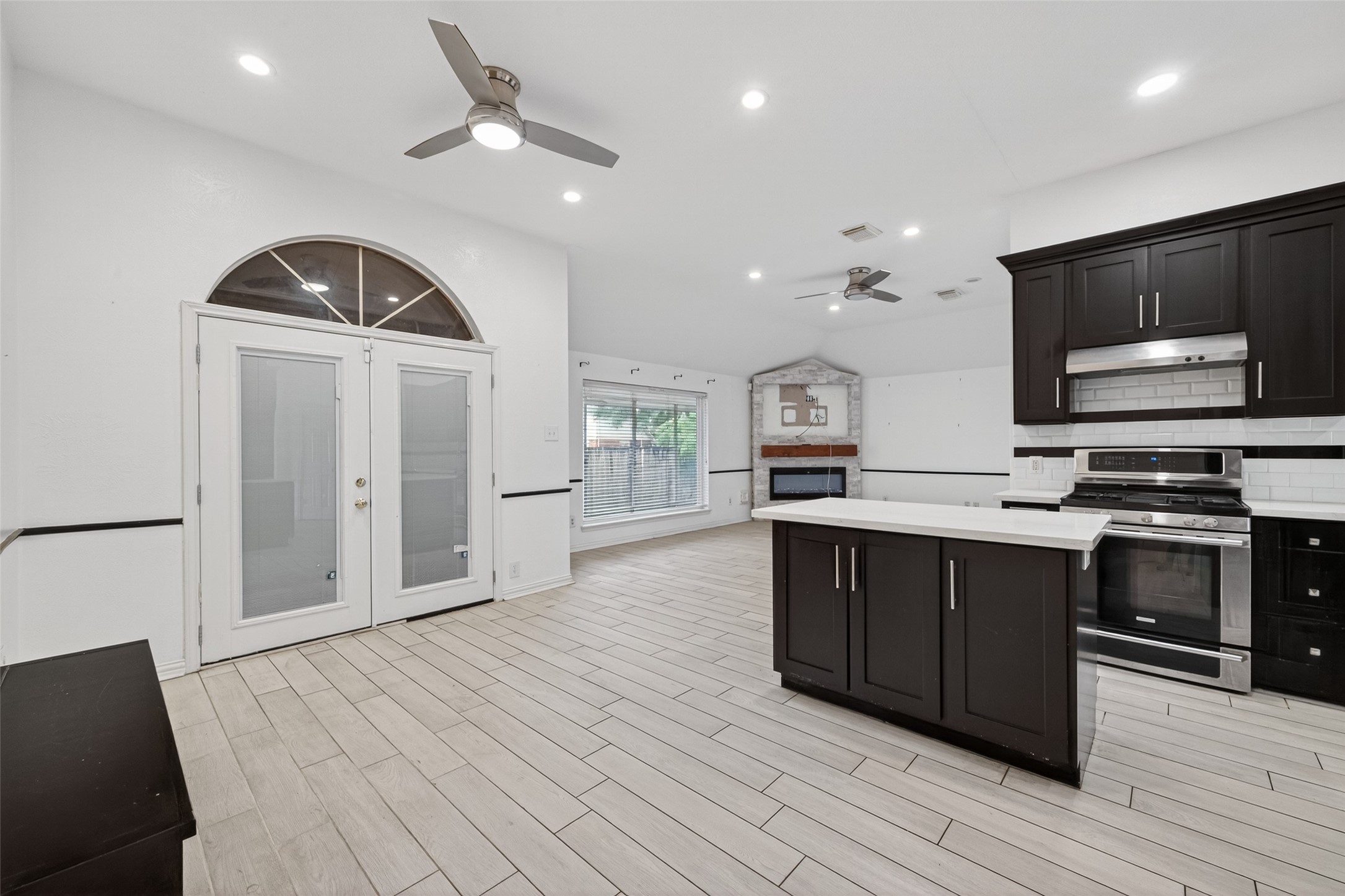 2214 Ruffian Lane Stafford, TX 77477 - Photo 13 of 31 a kitchen with stainless steel appliances a stove cabinets and wooden floor
