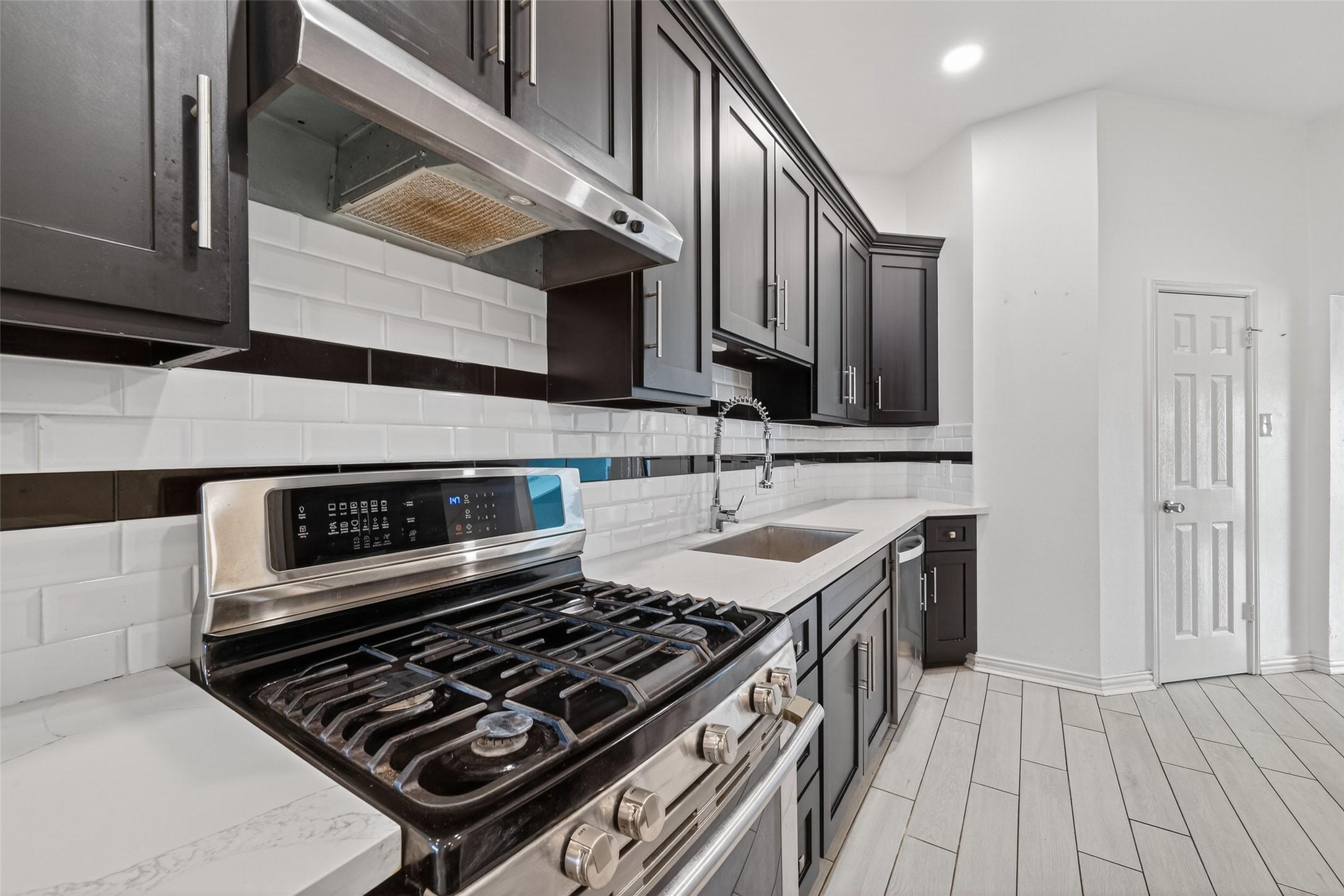 2214 Ruffian Lane Stafford, TX 77477 - Photo 19 of 31 a kitchen with a stove and a sink