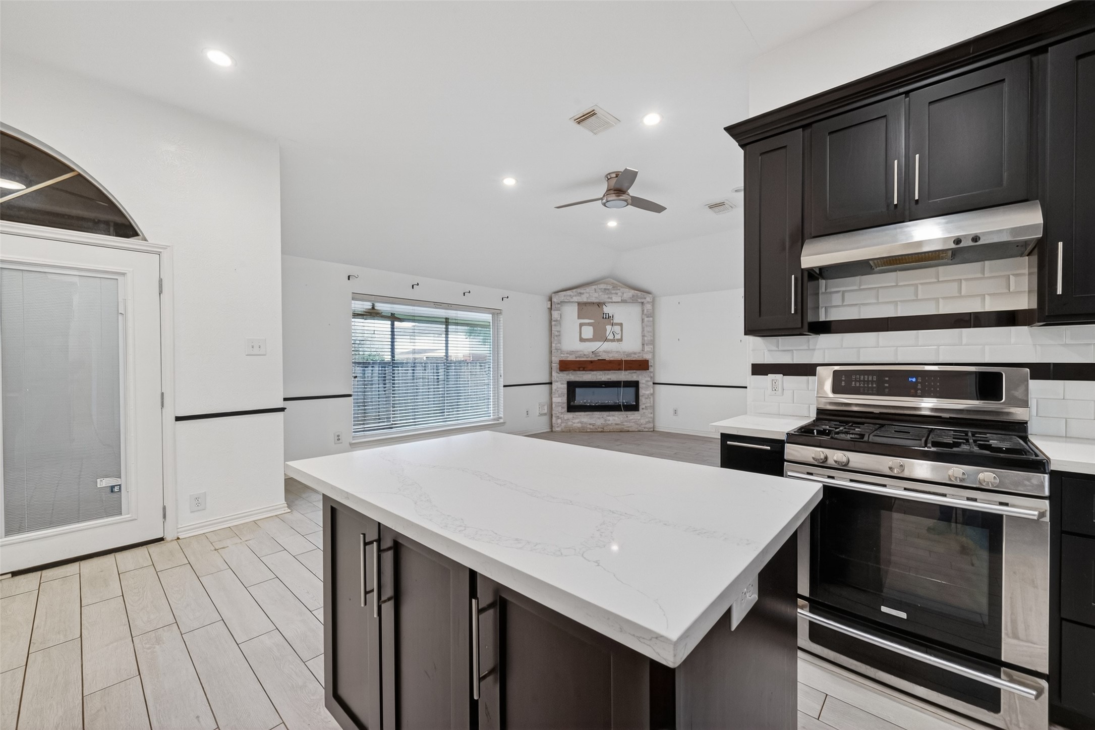 2214 Ruffian Lane Stafford, TX 77477 - Photo 21 of 31 a kitchen with a stove a microwave and wooden floor