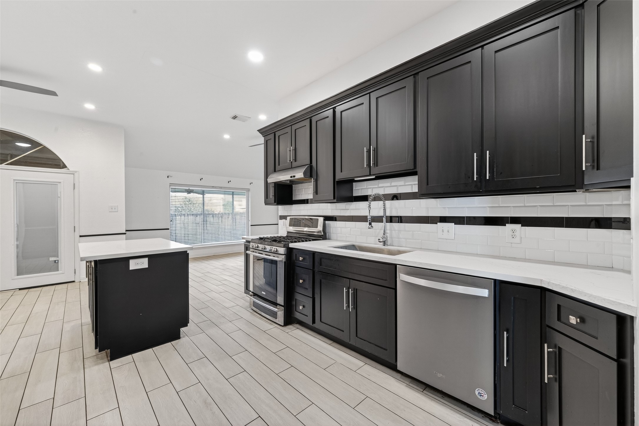 2214 Ruffian Lane Stafford, TX 77477 - Photo 22 of 31 a kitchen with stainless steel appliances granite countertop a sink stove and cabinets