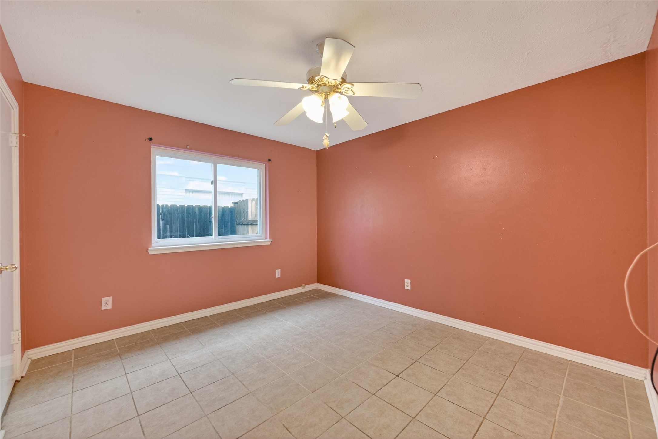 2214 Ruffian Lane Stafford, TX 77477 - Photo 28 of 31 an empty room with a chandelier fan and windows