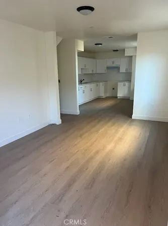 a large white kitchen with white cabinets