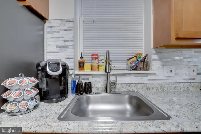 a kitchen with granite countertop cabinets stainless steel appliances and sink