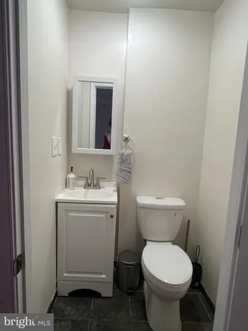 a view of a brick house with a yard and pathway