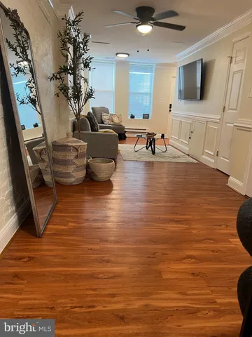a dining room with furniture and wooden floor