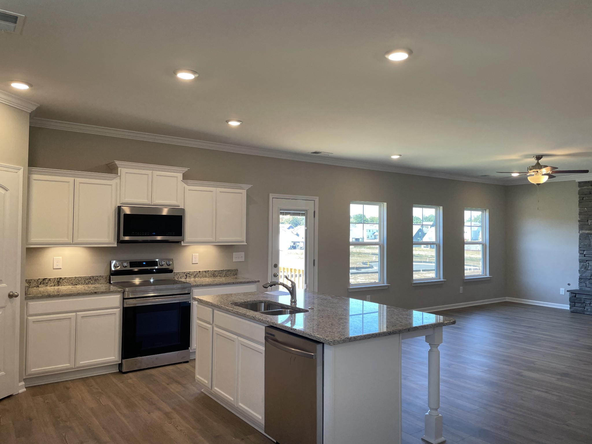 1038 Wiseman Farm Road Fairview, TN 37062 - Photo 3 of 11 a kitchen with granite countertop stainless steel appliances and wooden cabinets