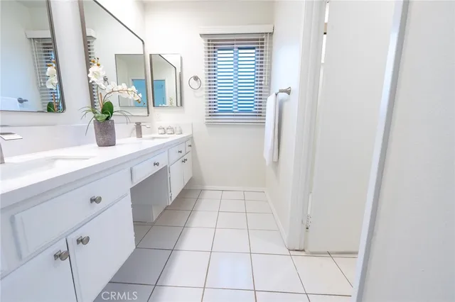 a bathroom with a granite countertop sink a mirror and a shower