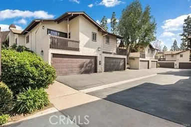 a view of a house with a tree and plants