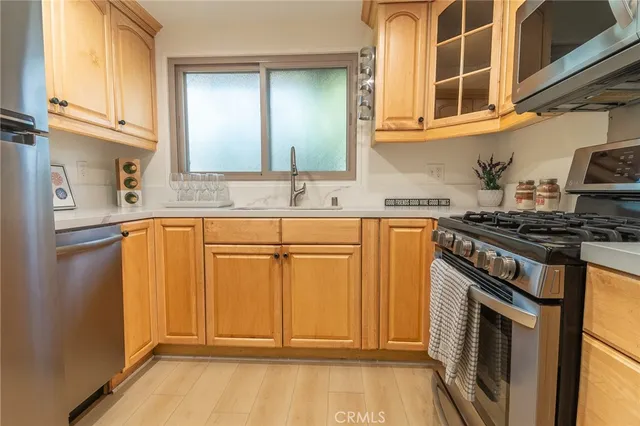 a kitchen with granite countertop a sink stove and cabinets