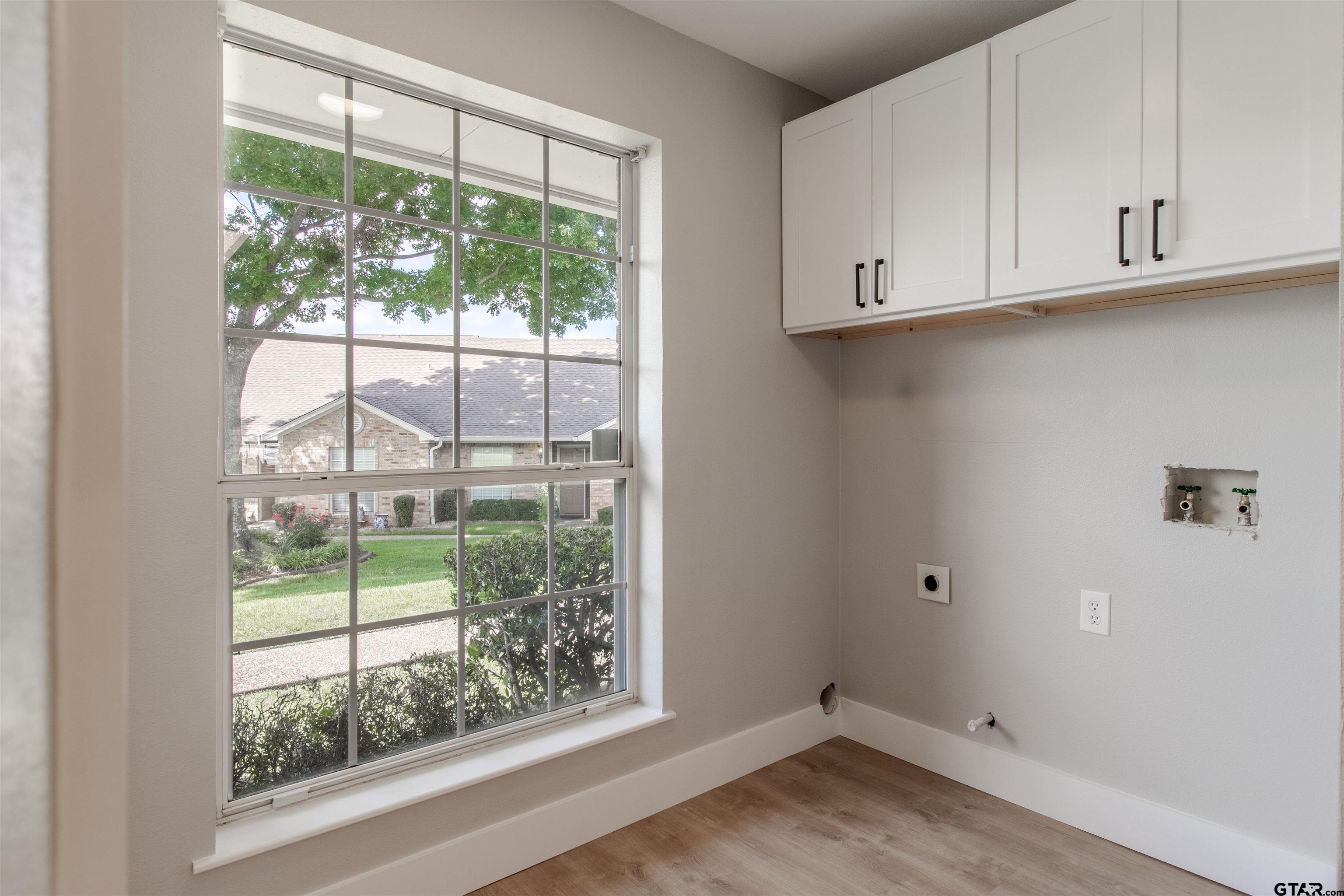 415 Thigpen Drive Tyler, TX 75703 - Photo 16 of 32 a view of a kitchen with wooden floor and a window