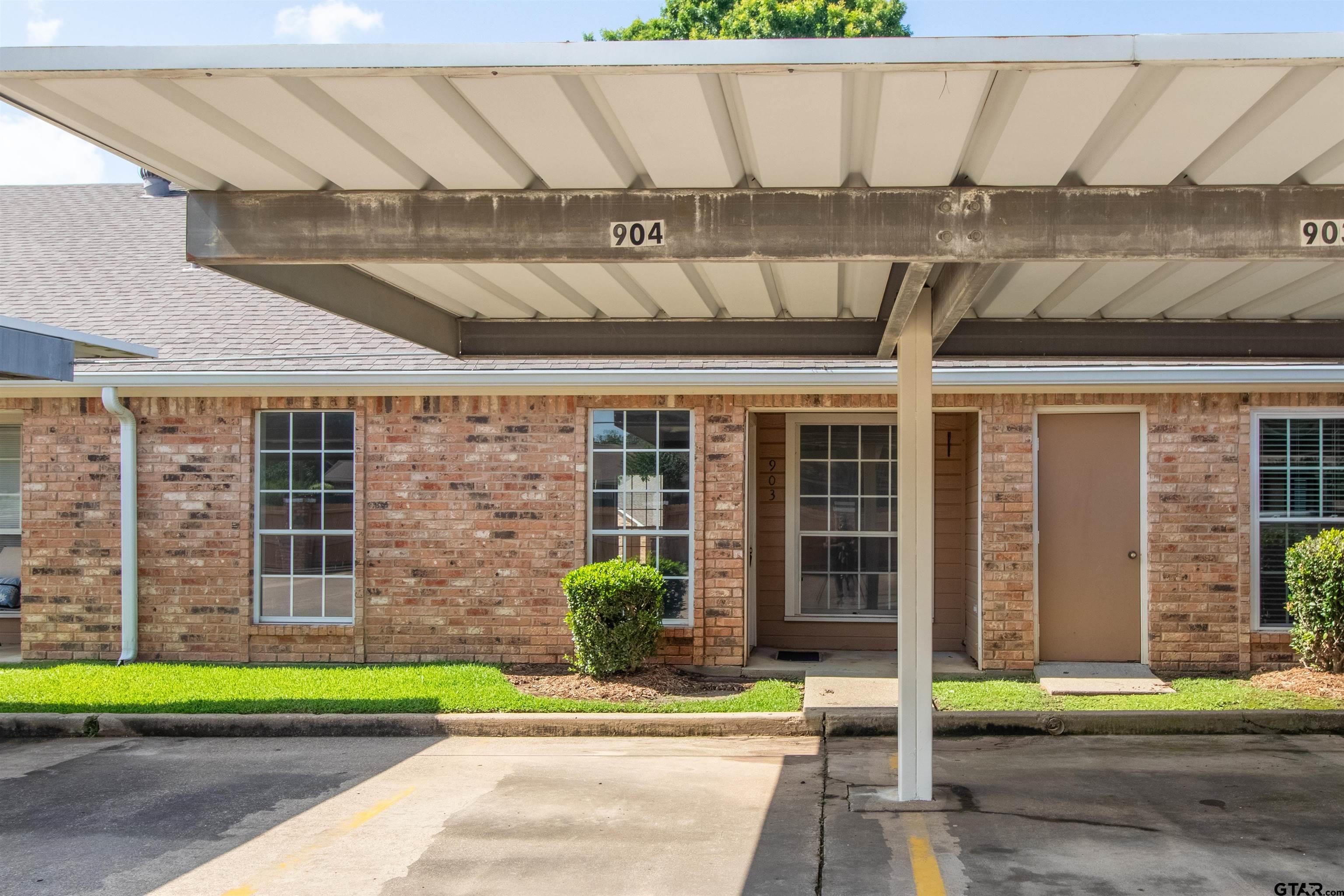 415 Thigpen Drive Tyler, TX 75703 - Photo 32 of 32 a front view of a house with a garden and plants