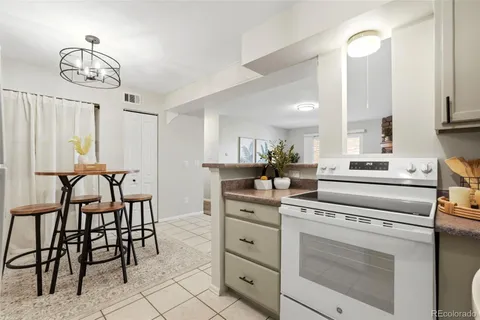 a kitchen with appliances cabinets and a table