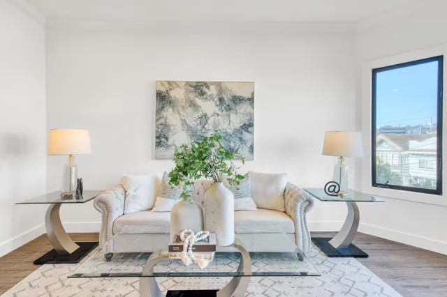 a living room with furniture and a potted plant
