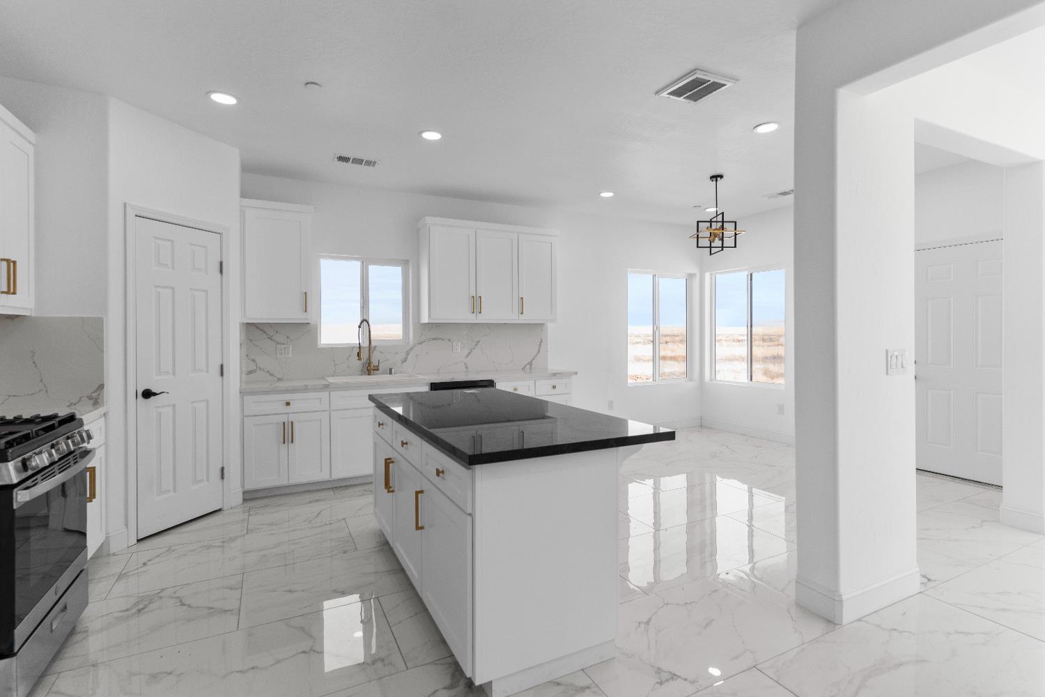 36950 Pauline Avenue Madera, CA 93636 - Photo 11 of 48 a kitchen with stainless steel appliances granite countertop a stove and a refrigerator