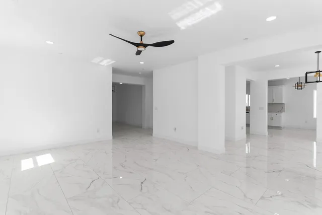 wooden floor in an empty room with a ceiling fan