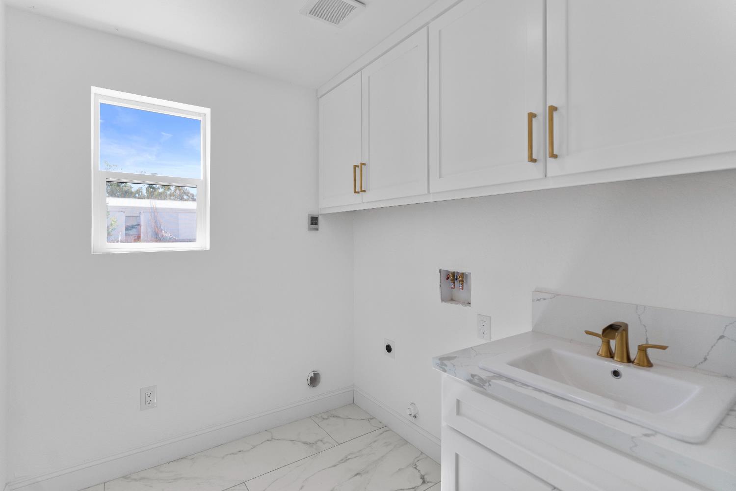 36950 Pauline Avenue Madera, CA 93636 - Photo 17 of 48 a bathroom with a sink and cabinets