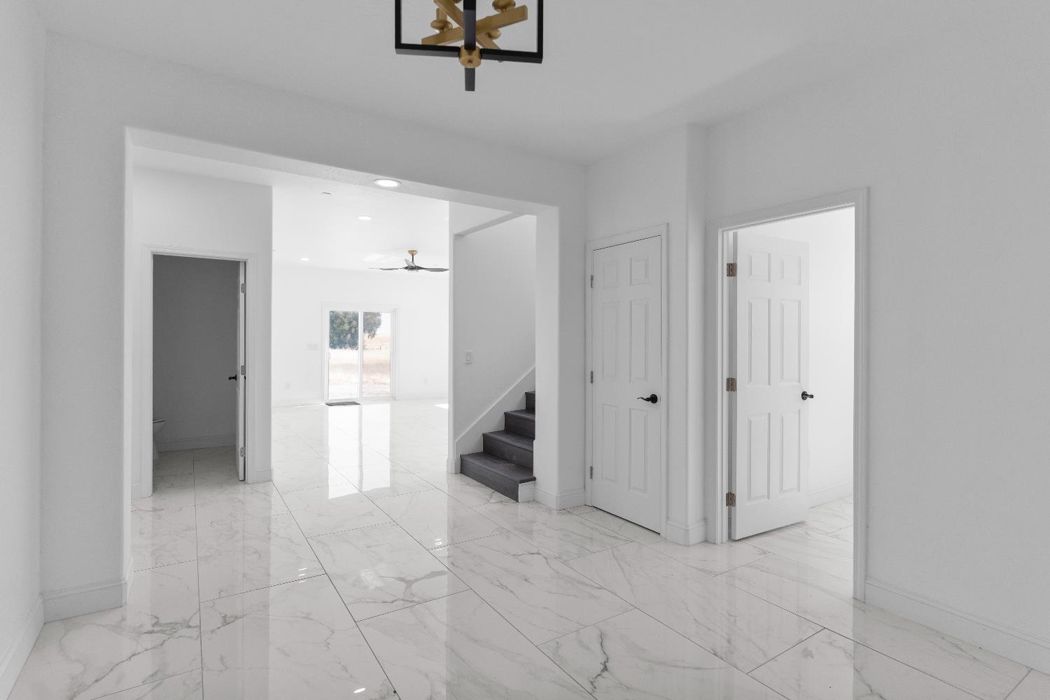 36950 Pauline Avenue Madera, CA 93636 - Photo 18 of 48 a view of a hallway with closet and a living room