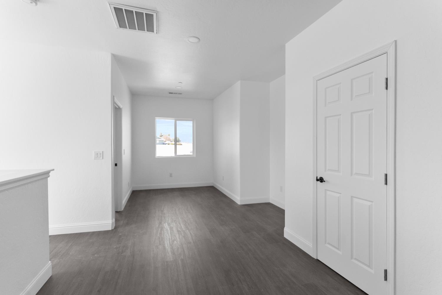 36950 Pauline Avenue Madera, CA 93636 - Photo 19 of 48 an empty room with wooden floor and a window