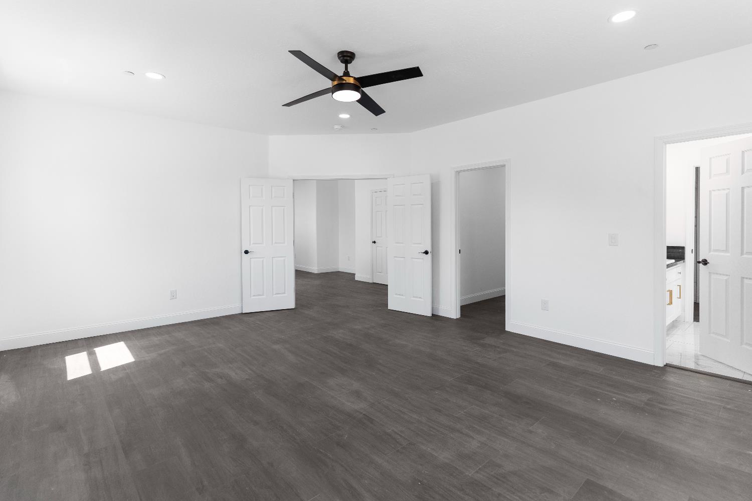 36950 Pauline Avenue Madera, CA 93636 - Photo 26 of 48 a view of a livingroom with a hardwood floor and a ceiling fan