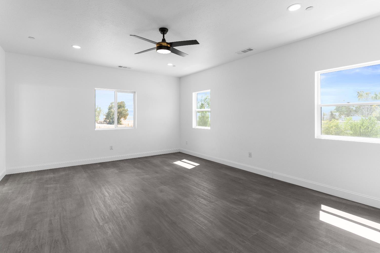 36950 Pauline Avenue Madera, CA 93636 - Photo 27 of 48 a view of an empty room with a window and wooden floor