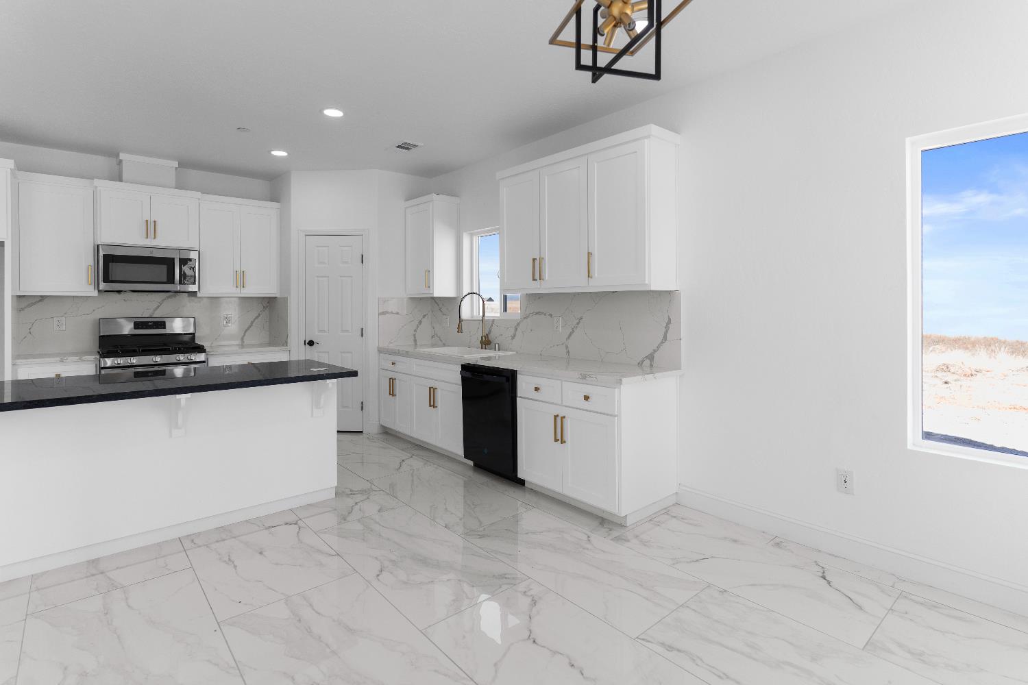 36950 Pauline Avenue Madera, CA 93636 - Photo 6 of 48 a kitchen with granite countertop white cabinets and stainless steel appliances
