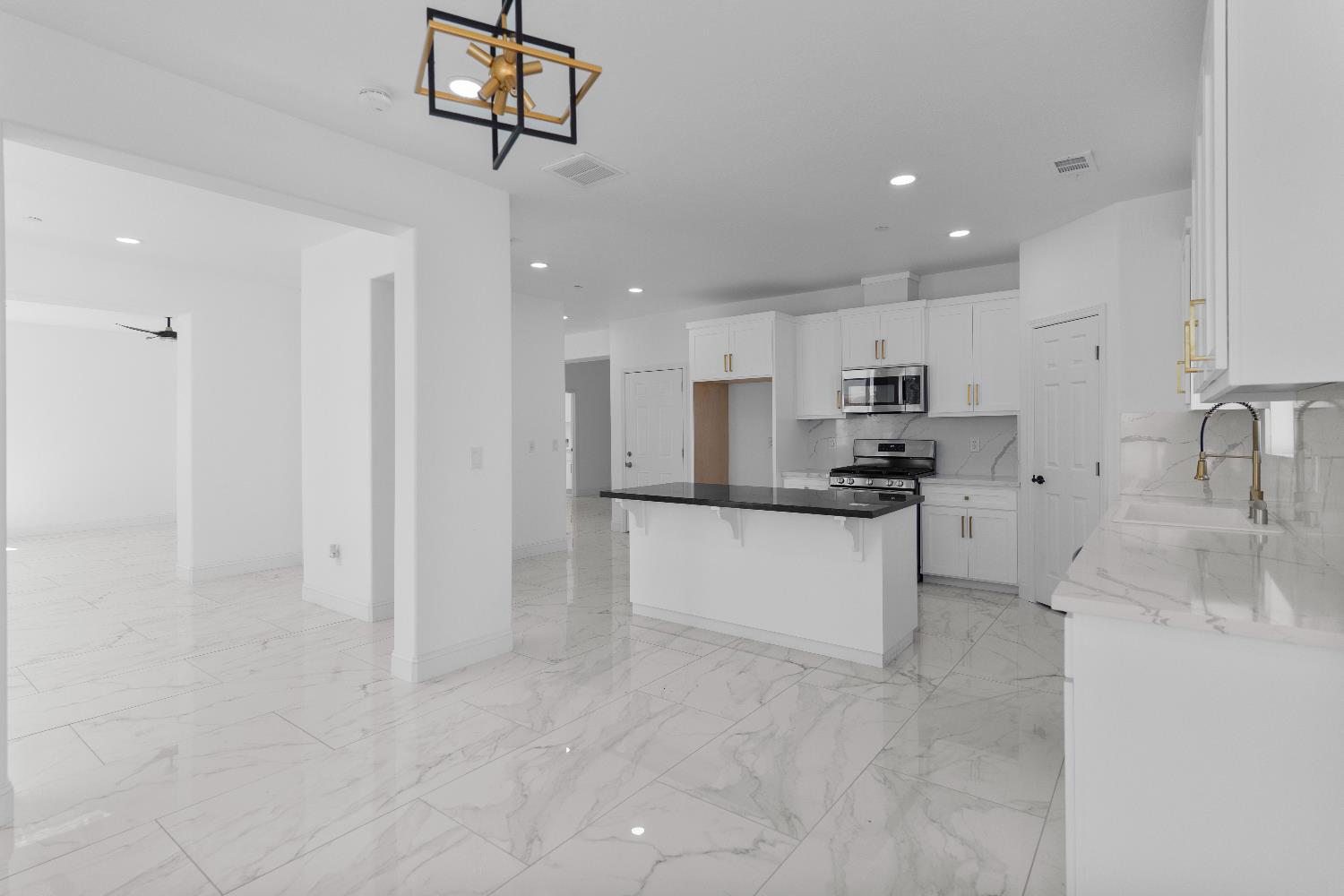 36950 Pauline Avenue Madera, CA 93636 - Photo 7 of 48 a kitchen with stainless steel appliances granite countertop a refrigerator and a sink