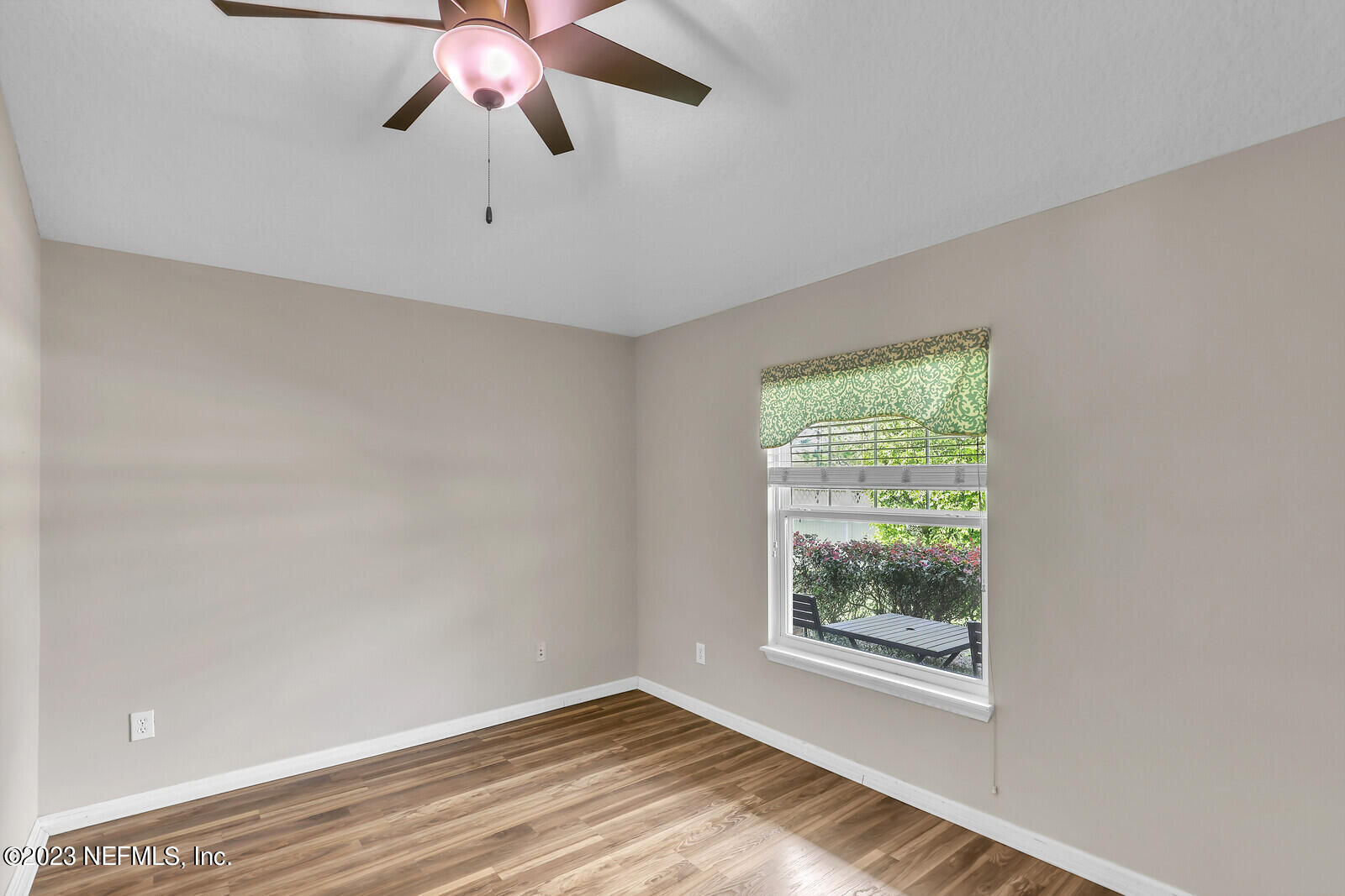 951 Silver Spring Court St. Augustine, FL 32092 - Photo 13 of 17 a view of an empty room with wooden floor and a window