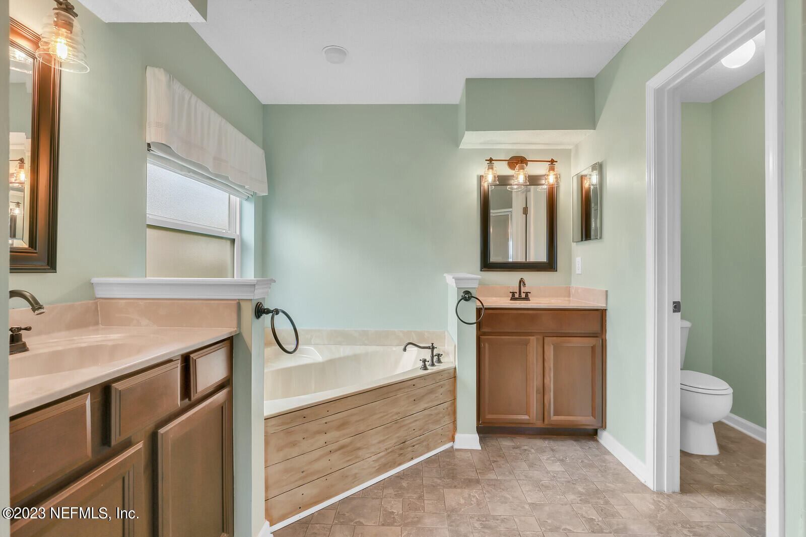 951 Silver Spring Court St. Augustine, FL 32092 - Photo 15 of 17 a bathroom with a tub sink and mirror