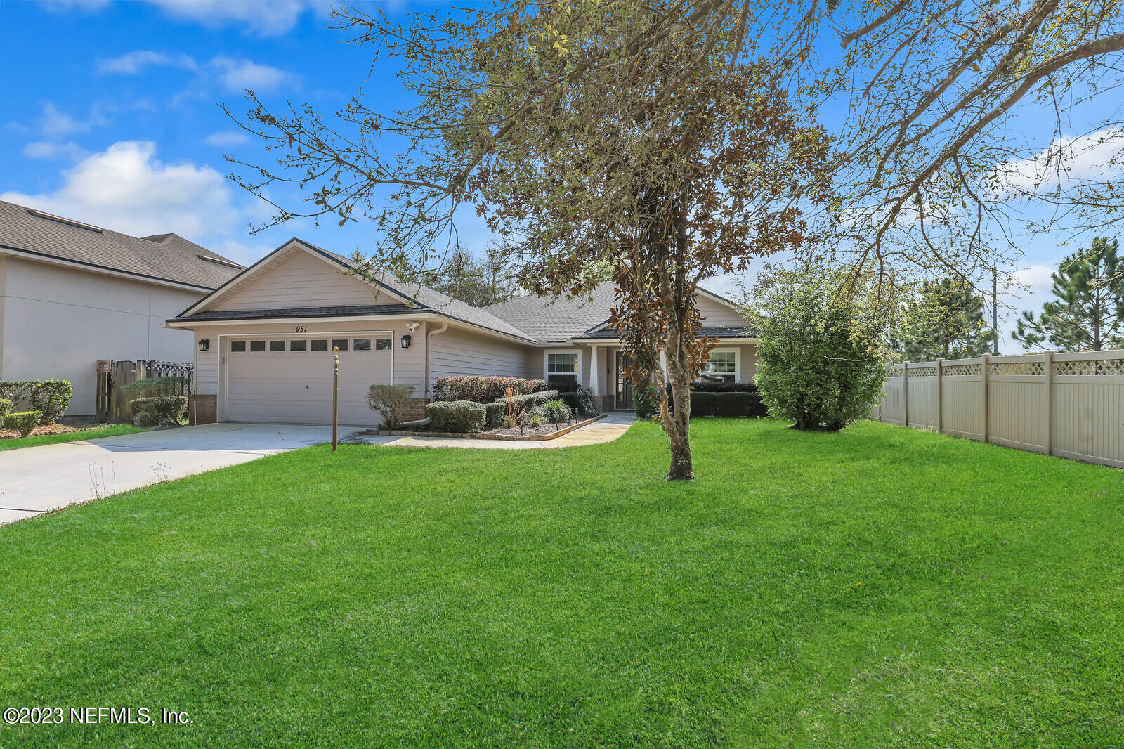 951 Silver Spring Court St. Augustine, FL 32092 - Photo 2 of 17 a view of a house with a big yard potted plants and a large tree